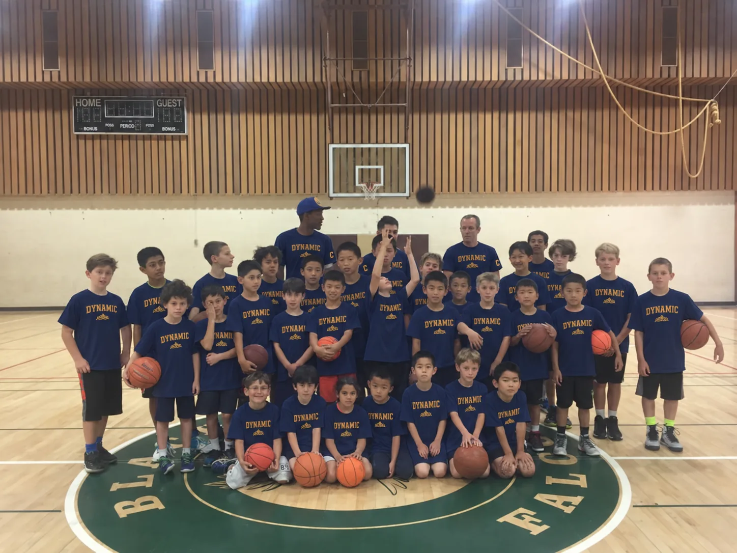 Dynamic Sport youth team with coaches in the gym