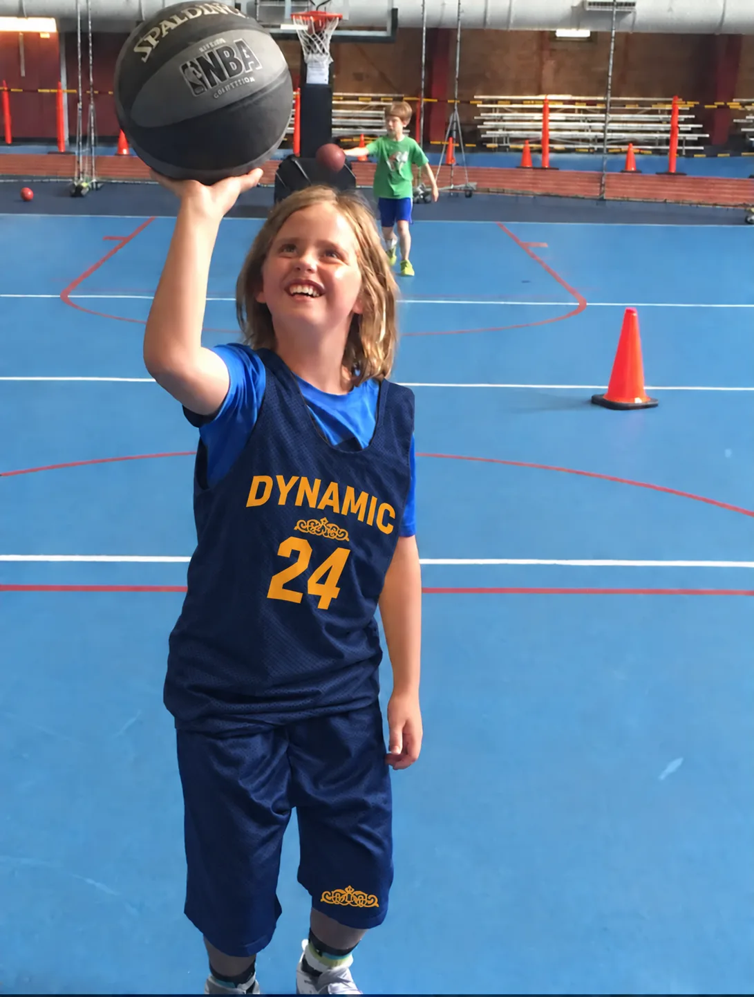 Smiling young player shooting at practice